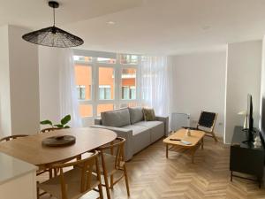 a living room with a couch and a table at Praia - Boa Onda in Cee
