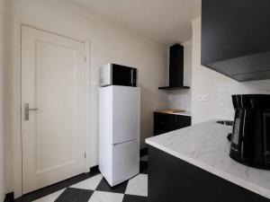 a kitchen with a white refrigerator with a microwave on top at 'tNest Middelaar in Middelaar +15 photos