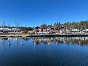 a body of water with a bunch of houses at Stor villa med jacuzzi in Herräng