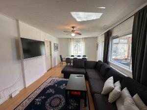 a living room with a couch and a table at Stor villa med jacuzzi in Herräng