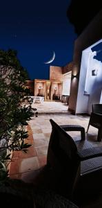 a view of a patio at night with a moon at Dar Essaada - Exceptionel duplex de 270 M2, plage à 2 min à pieds in Mahdia