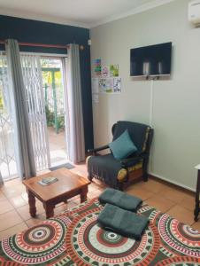 a living room with a chair and a coffee table at Anri Guesthouse in Bloemfontein