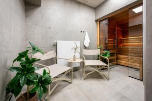 a dining room with two chairs and a table at Iron Apartments by MB Apartments in Krakow