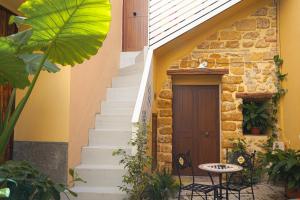 a set of stairs leading up to a house with a door at BeB Omare Agrigento in Agrigento