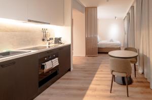 a kitchen with a sink and a table and a bed at Stay at Brussels in Brussels