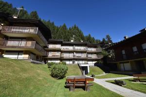 a building with a picnic table in front of it at Presanella View Studio Mhd in Madonna di Campiglio