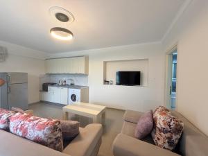a living room with two couches and a table at Villa Aleandro in Ksamil