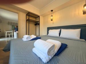 a bedroom with a bed with towels on it at Villa Aleandro in Ksamil +58 photos