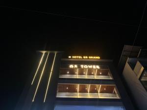a building at night with a sign on it at Hotel GS GRAND in Dehradun
