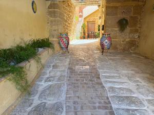 two vases are sitting on a stone walkway at BeB Omare Agrigento in Agrigento +14 photos