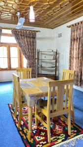 a dining room table with two chairs and a table and a table and chairsktop at Comfort Inn in Chitral +25 photos