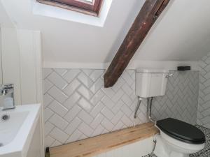 a bathroom with a toilet and a sink at Wheelwright Cottage in Moreton in Marsh +13 photos