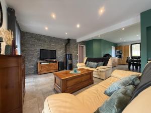 a living room with a couch and a tv at Iduzki-alde bi in Souraïde