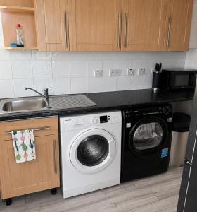 a kitchen with a washing machine and a sink at 2BR Mariners Stay - Newhaven in Newhaven