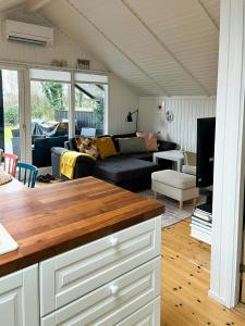 a living room with a couch and a table at Summer House With Authentic Charm On Enø in Karrebæksminde