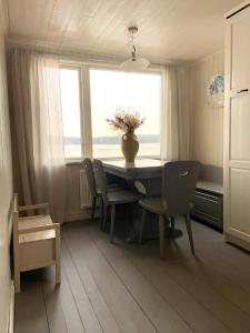 a dining room with a table and chairs and a window at Romantic Summer House On Orust in Stillingsön