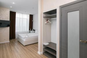 a bathroom with a bed and a mirror in a room at Astra City Hotel in Almaty +33 photos