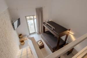a room with a staircase with a piano in it at Jo&Co Mykonos Nature Suites N3 in Plintri