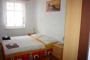 a small bedroom with a bed and a window at Ubytování Sušice in Sušice