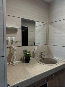 a bathroom with a sink and a mirror at Отель Бестау in Aksay +23 photos
