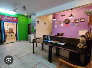 a teddy bear sitting on a desk in a room at hotel gsa & guest house in Haridwār