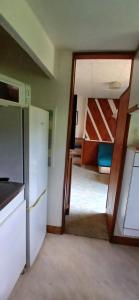 a kitchen with a door leading to a bunk room at Studio privatif in Figeac
