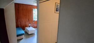 a bathroom with a sink and a door to a room at Studio privatif in Figeac +2 photos