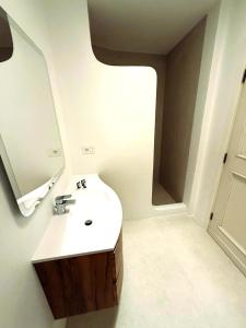 a bathroom with a sink and a mirror at GG Luxury Apartments - Porto Cervo - Costa Smeralda in Porto Cervo