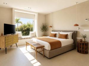 a bedroom with a large bed and a window at Villa Ainé Luxury Villa, Sea Views, Heated pool in Puerto Calero +26 photos