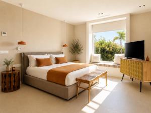 a bedroom with a large bed and a window at Villa Ainé Luxury Villa, Sea Views, Heated pool in Puerto Calero
