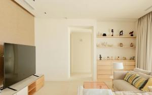 a living room with a television and a couch at Villa Ainé Luxury Villa, Sea Views, Heated pool in Puerto Calero
