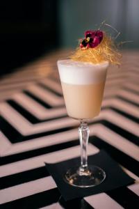 a drink with a flower on top of a table at Montcalm Royal London House, London City in London