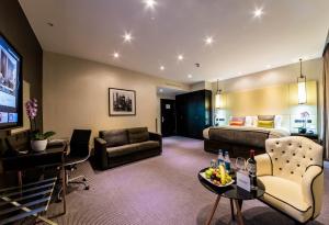 a hotel room with a bed and a living room at Montcalm Royal London House, London City in London