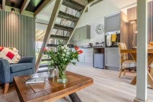 a living room with a vase of flowers on a table at 1 Bed in Tilbrook oc-a40241 in Tilbrook