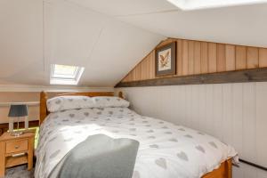 a bedroom with a large bed in a attic at 1 Bed in Tilbrook oc-a40241 in Tilbrook