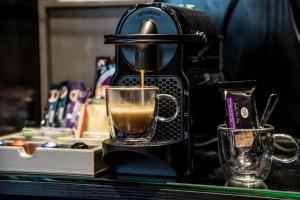 a coffee maker is making a cup of coffee at Montcalm Royal London House, London City in London