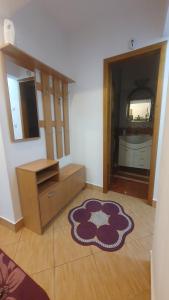 a living room with a rug on the floor at Apartament RHC in Târgu Ocna +3 photos