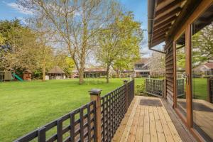 a house with a wooden porch with a yard at 1 Bed in Tilbrook oc-a40241 in Tilbrook