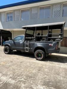 a gray jeep parked in front of a building at Yala Dream Guest House in Tissamaharama