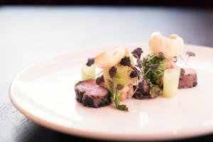 a white plate with food on a table at Montcalm Royal London House, London City in London