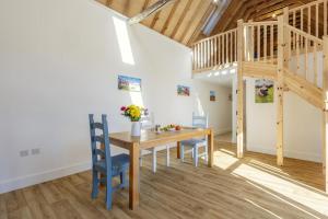 a dining room with a wooden table and blue chairs at 1 Bed in Barrow oc-b42640 in Barrow +10 photos