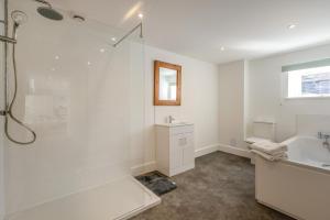 a white bathroom with a shower and a tub and a sink at 1 Bed in Barrow oc-b42640 in Barrow
