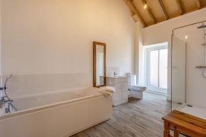 a white bathroom with a tub and a toilet at 2 Bed in Barrow oc-b42642 in Barrow +20 photos