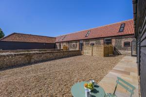 a courtyard of a building with a table and chairs at 2 Bed in Barrow oc-b42642 in Barrow