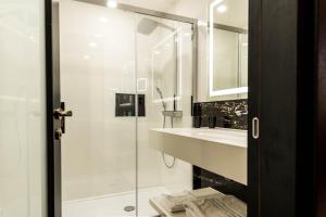 a bathroom with a shower and a sink at Montcalm Royal London House, London City in London