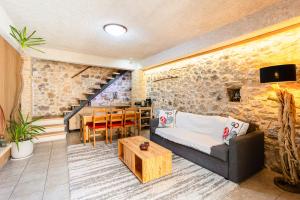 a living room with a couch and a table at Limni Stone Apartments in Límni