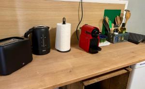 a counter with a coffee maker and a roll of paper towels at Chez le Sabotier, central et confortable in Rosières