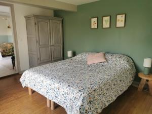 a bedroom with a bed with a pillow on it at La petite FloPée in Le Mont-Saint-Adrien