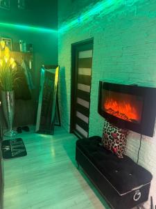 a fireplace in a living room with a black couch at Krakowska in Tarnów