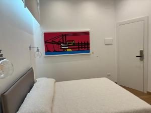 a bedroom with a bed and a painting on the wall at Corsica Rooms in Termoli